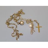 A yellow metal cross pendant, to a fine link chain, gross weight 1gm, together with a simulated
