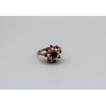 A garnet and split pearl set starburst cluster ring in 9ct gold, size T. Gross weight approximately