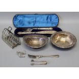 A box of silver plated items to include serving dishes and an ornate cased set of fish servers.