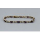 A 9ct gold amethyst and diamond bracelet. Approximate weight 7.3 grams. 19cms in length