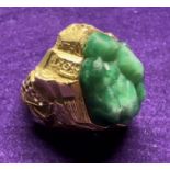 A French Brutalist ring. Set with a large piece of green moulded glass, with gold flecks, in the