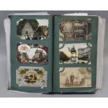 An Edwardian postcard album, containing several dozen cards, including regimental and other