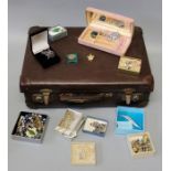 A small suitcase containing a mixed parcel of silver, yellow metal and other costume and paste set