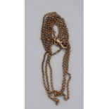 A yellow metal guard chain, with a gilded clip marked "solid silver". Approximate weight 13.2