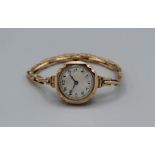 A 9ct gold (London 1923) ladies wristwatch with silvered dial and arabic numerals. Winds and appears