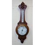 An Edwardian oak aneroid wheel barometer with enamel dial and thermometer to neck, 88cm