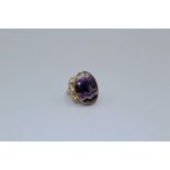 A 9ct gold Celtic style ring, set with a large cabochon of Blue John, size R. Gross weight