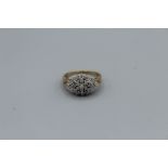 A diamond cluster ring in yellow metal, size N. Estimated 0.75ct diamonds, twenty five stones, 3gm