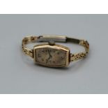Rolex, an early 20th century lady's 9ct gold cased wristwatch, the rectangular case numbered 69494/
