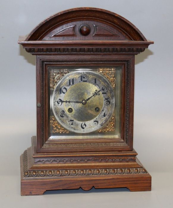 A late 19th century mantle clock, the architectural oak case containing an eight day movement