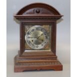 A late 19th century mantle clock, the architectural oak case containing an eight day movement