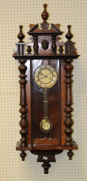 An Edwardian walnut and beech cased Vienna wall clock, the eight day movement striking upon a