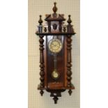 An Edwardian walnut and beech cased Vienna wall clock, the eight day movement striking upon a