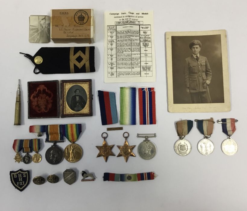 A selection of WW1 and WW2 medals, badges, photographs and other items. To include: a BWM and