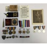 A selection of WW1 and WW2 medals, badges, photographs and other items. To include: a BWM and