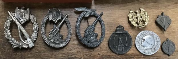 A selection of German / Austro-Hungarian medals and badges. To include: a WW1 iron cross 2nd