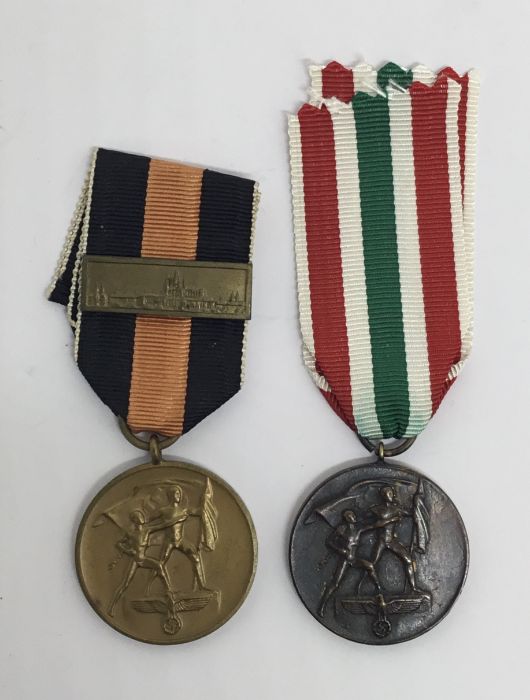 2 WW2 era German medals. To include: a Sudentenland Medal with Prague Castle Bar, plus a Memel