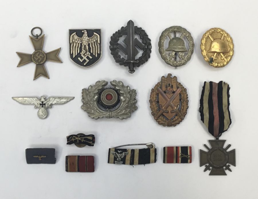 A selection of WW1 and WW2 German medals, badges and insignia. To include: a WW2 war merit cross