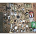 Collection of Military cap and uniform badges, belt buckles, button sticks with other badges. See