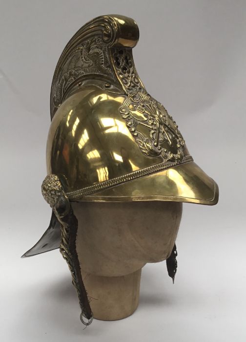 A late 19th / early 20th century brass fireman’s helmet by Merryweather & Sons of London. Standard