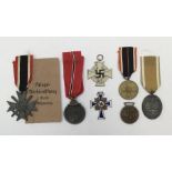 A selection of WW2 era German medals. To include: a War Merit Cross with sword (with paper