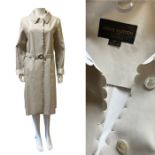 A Louis Vuitton coat in waxed canvas with scalloped edging and mother of pearl buttons, complete
