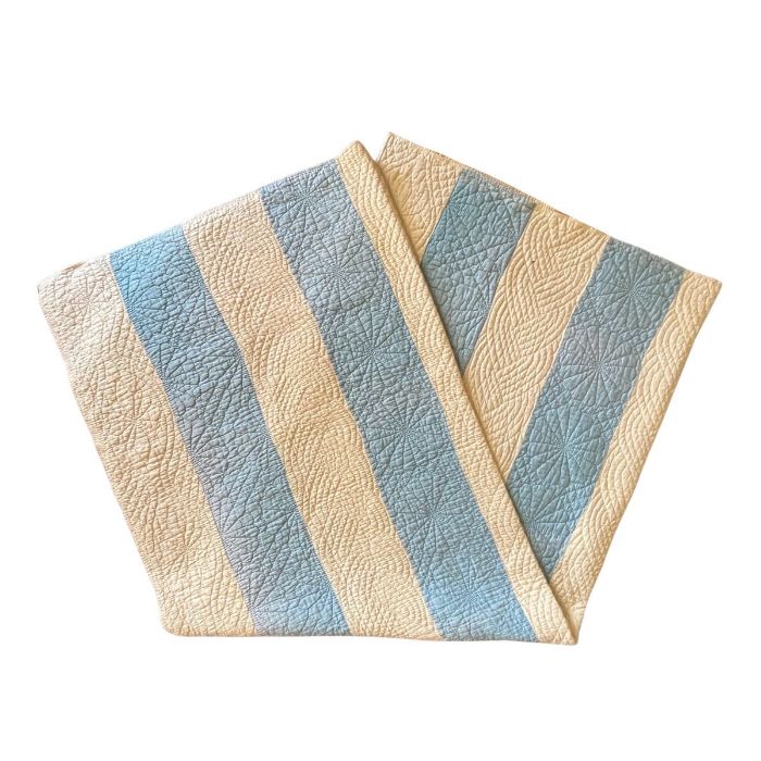 A blue and soft cream striped Durham quilt, the reverse being cream.225 x 180 cm. The vendor