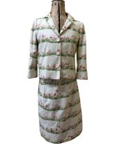 A Moschino Cheap and Chic suit in a cotton blend pique. The cream suit has printed bands of grass