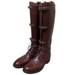 A pair of mid-century brown leather equestrian boots, possibly military with laces and buckled