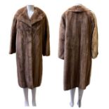A vintage honey mink coat with three hook fastening and lapels, taupe satin lining and swing ties 44