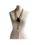 Two Chinese, hand knotted agate necklaces in the flapper style. One terminates with a carved