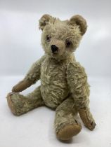 Antique 17” teddy bear with long clipped mohair snout, amber black glass eyes, cup ears and original