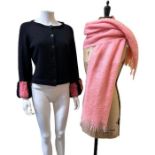 A 1960s cardigan with wide neck and wide sleeves finished with pink and black striped faux fur