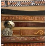 A good group of buckled belts and buckles including tooled leather and Tony Lama Western belts (qty)