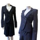 A navy blue women's suit, Armani Collezioni, the jacket having a deep neckline and two large buttons