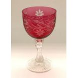 A ruby flash glass on clear chalice shaped vase on a clear cut crystal stem, decorated with a floral