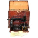 A late 19th Century Hopkinson Bros sewing machine within a wooden carry case
