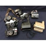 A collection of cameras to include: Pentax Spotmatic F, Pentax Me super, Polaroid 600 Land Camera,