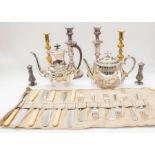 A collection of silver plated ware to include; a pair of large Sheffield plate style candlesticks, a