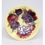 Moorcroft Pottery, an "Anenome" design plate with yellow ground, factory impressed mark and