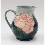 Moorcroft: A Rose patterned water jug, marked Moorcroft Collectors Club and signed to underneath.