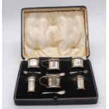 A collection of part silver condiment sets to include; a matching mustard pot, two salt cellars,