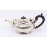 A George V silver oval teapot, bright cut engraved Neo-Classical style decoration, ebony finial