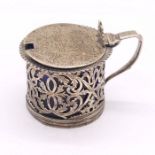 A Victorian pierced silver drum shaped mustard pot, with blue glass liner, engraved decoration to