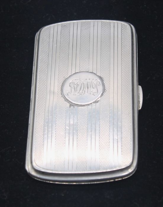 A George VI silver cigarette case, engine turned with stripped decoration, central circular