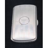 A George VI silver cigarette case, engine turned with stripped decoration, central circular