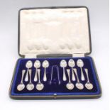 A set of twelve George V silver teaspoons with matching a pair of sugar tongs, all hallmarked