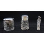 A collection of silver topped bottles/boxes to include; a cut glass Chester silver topped box, a