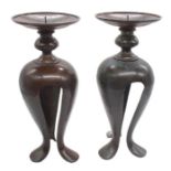 A pair of patinated bronze pricket Arts & Crafts candlesticks