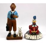A large wooden figurine of TinTin and Snowy, plus a large figure of Donald Duck (2)